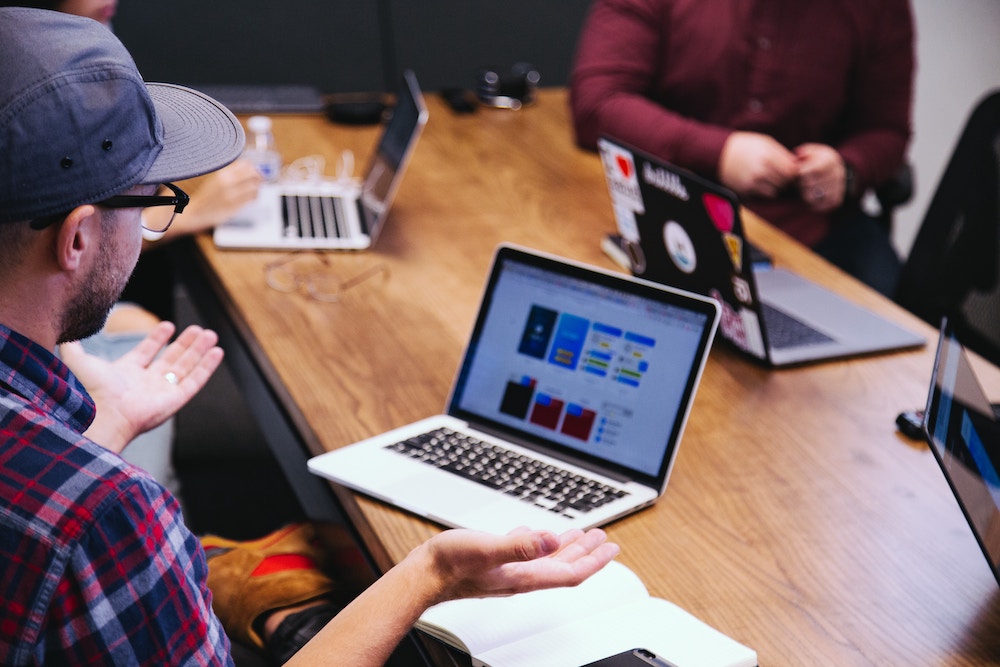 man in meeting in front of laptop
